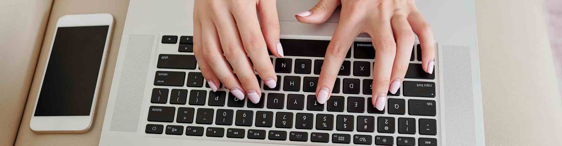 Hands typing in laptop